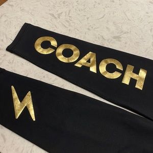 Inflow black full length legging. Back of calf design “coach” in gold.